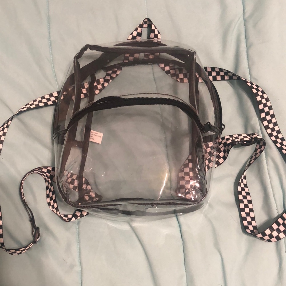 Black and white checker print mini backpack. Two pouches